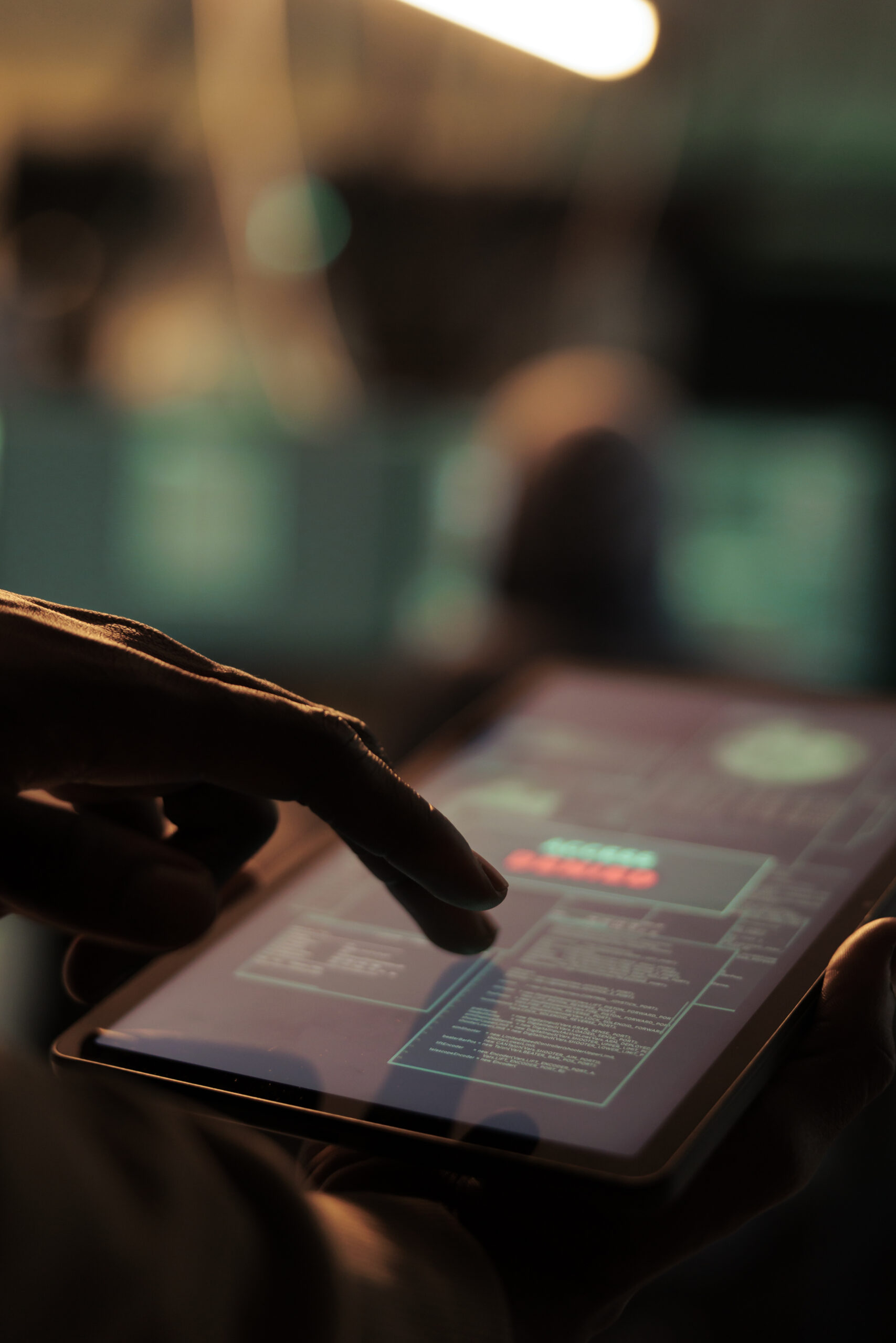 African american hacker holding tablet to hack online system, causing malware on network and planning cyberattack. Looking at security server to access database and steal passwords.