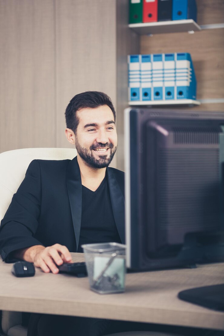 smiling-businessman-working-his-office-businessperson-professional-environment_482257-32723